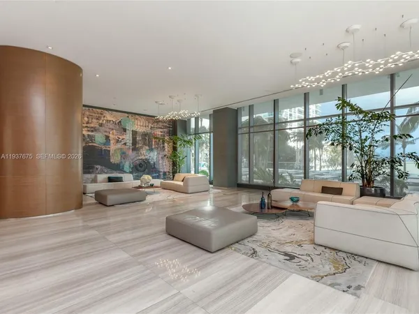 a living room with furniture and large windows