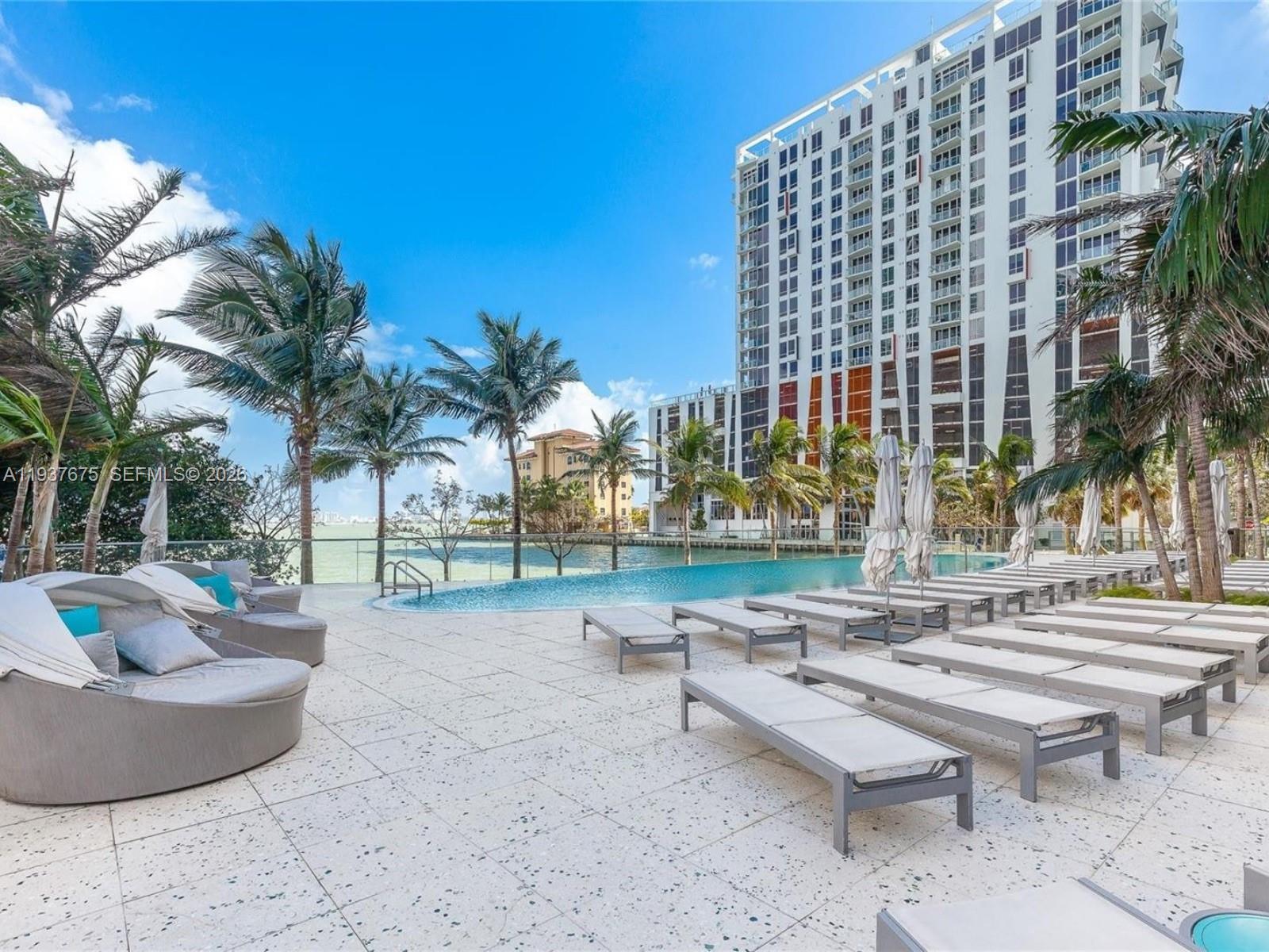 460 Northeast 28th Street, Unit 808 Miami, FL 33137 - Photo 40 of 41 a patio with a table and chairs and potted plants