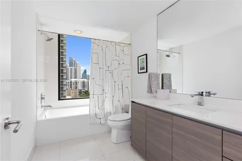 a spacious bathroom with a shower sink mirror and toilet