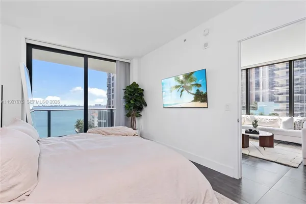 a bed sitting in a bedroom next to a window