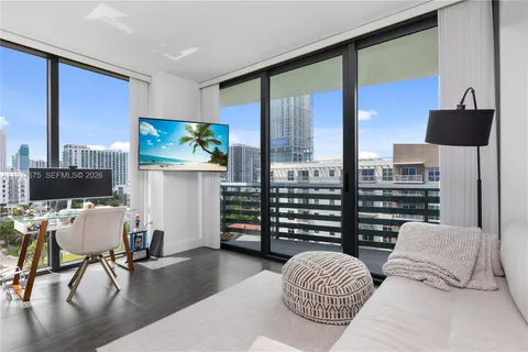 a bedroom with furniture and a flat screen tv