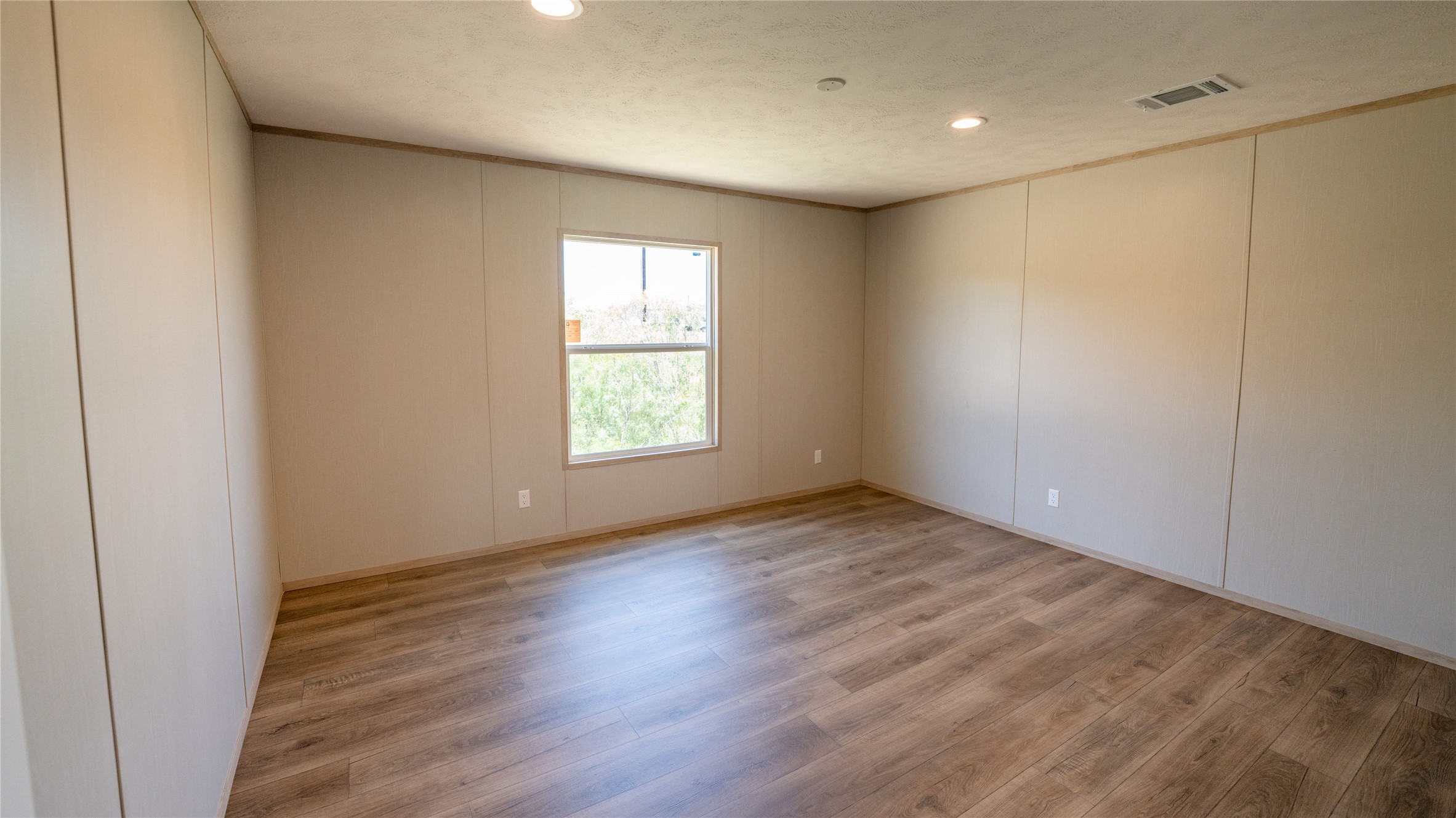 1145 Callihan Road Luling, TX 78648 - Photo 32 of 39 an empty room with wooden floor and windows