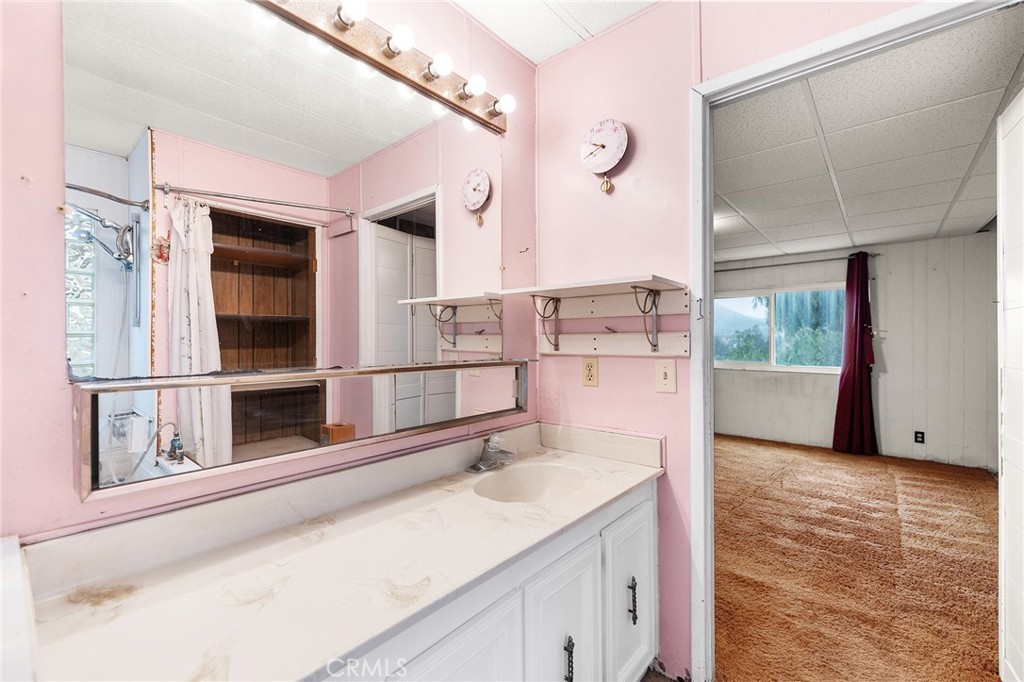 24469 Manzanita Road Menifee, CA 92584 - Photo 13 of 20 a kitchen with a sink and a large window