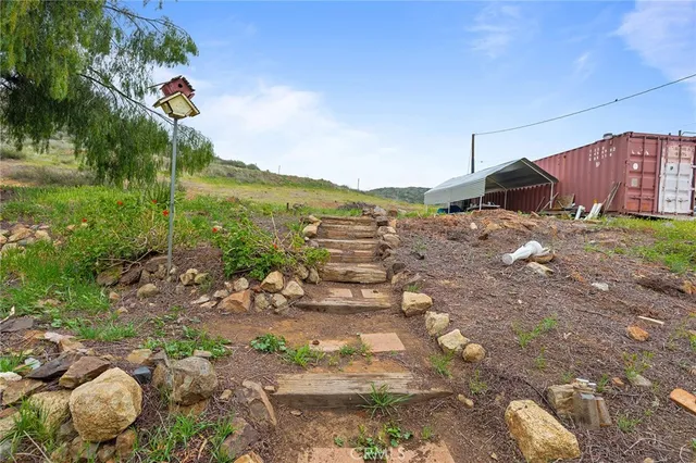 a view of a pathway of a house with a yard
