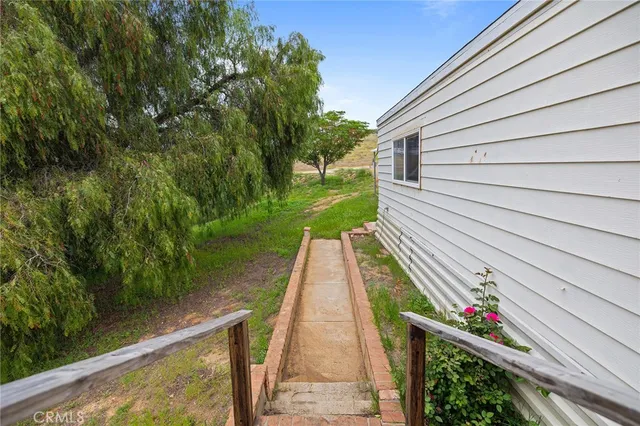 an aerial view of a house with a yard and lake view