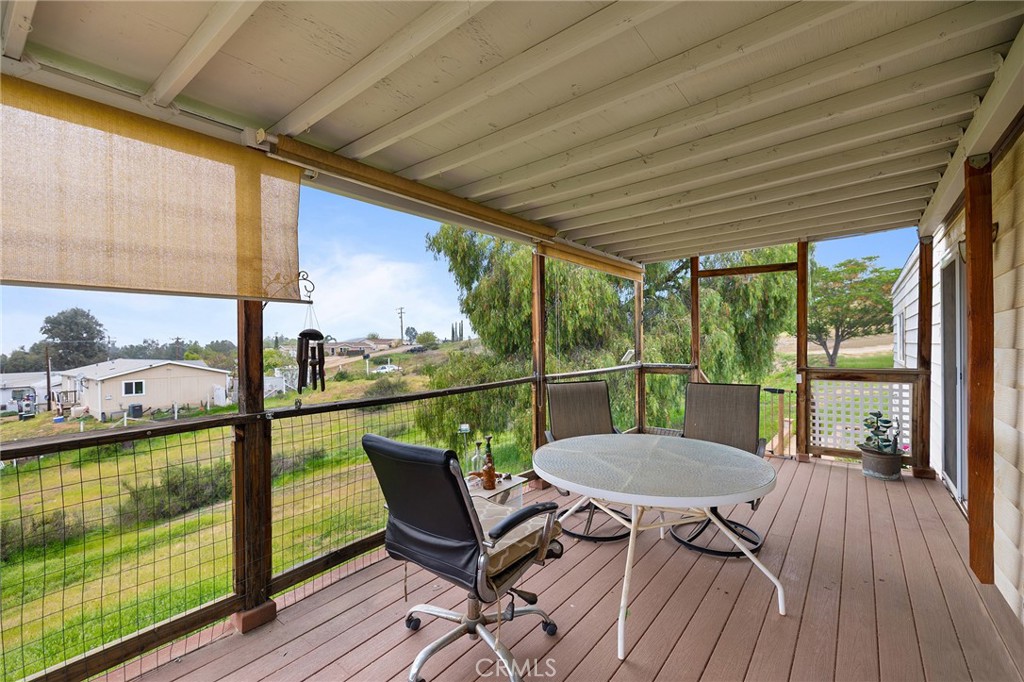 24469 Manzanita Road Menifee, CA 92584 - Photo 4 of 20 a view of a balcony with chair and wooden floor