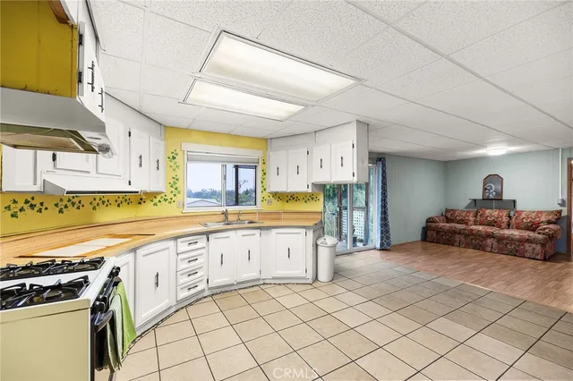 a large kitchen with cabinets and a stove