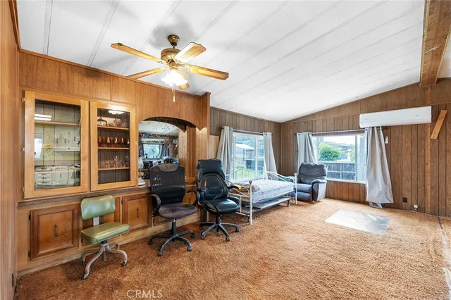 a living room with furniture a window and a chandelier
