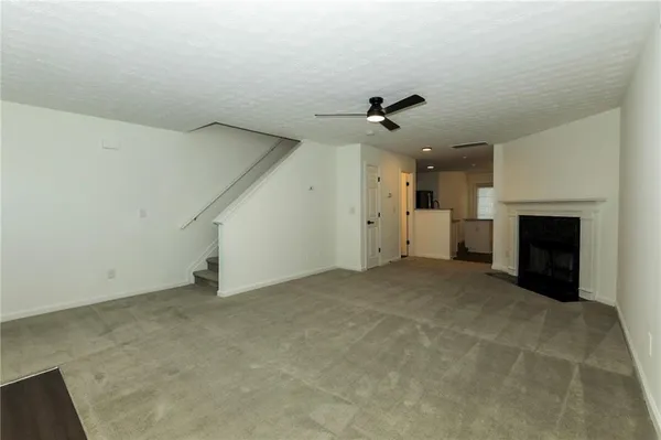 a view of empty room with a fireplace