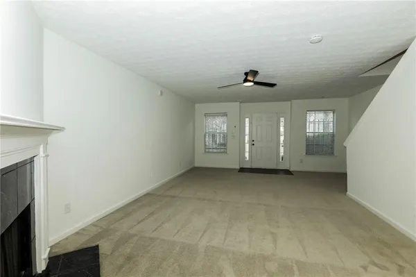 a view of a livingroom with an empty space and a fireplace