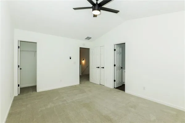 a view of a room with a ceiling fan