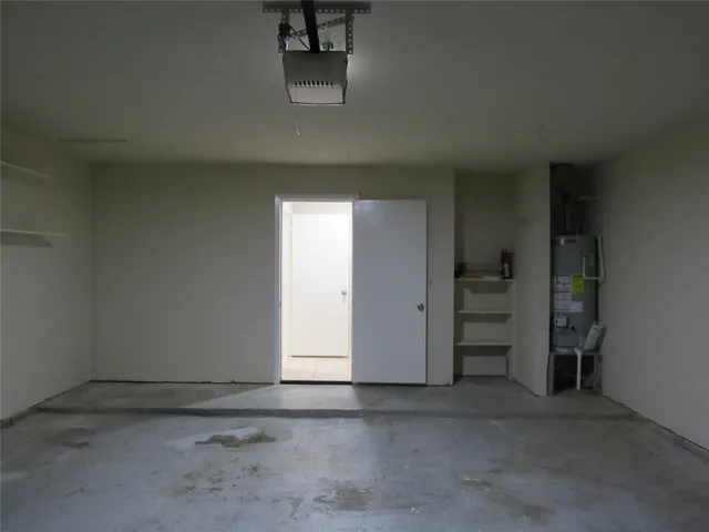 an empty room with fireplace and windows