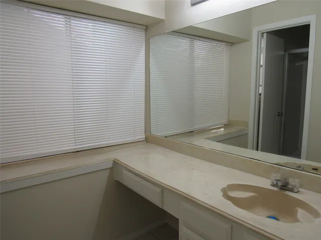 a bathroom with a granite countertop toilet and a shower