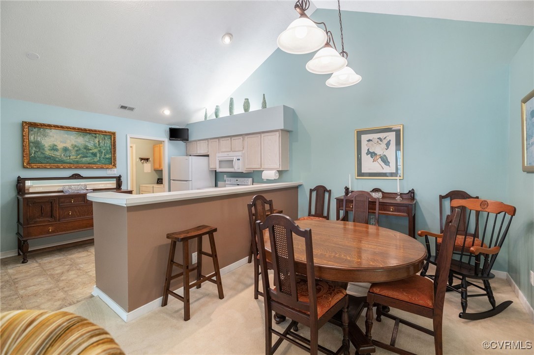1314 Tannery Circle Midlothian, VA 23113 - Photo 23 of 25 a kitchen with stainless steel appliances kitchen island granite countertop a dining table chairs and a refrigerator