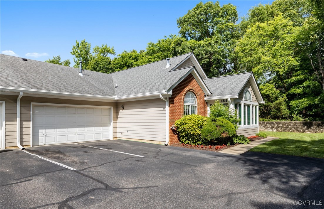 1314 Tannery Circle Midlothian, VA 23113 - Photo 7 of 25 a front view of a house with a yard and garage