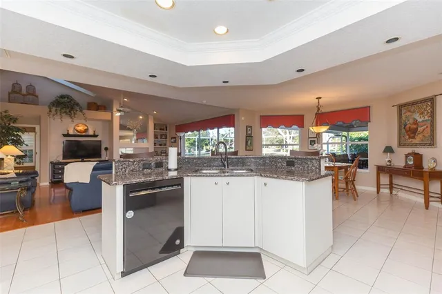 a kitchen with stainless steel appliances granite countertop a sink and cabinets