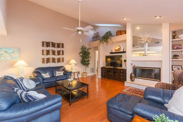 a living room with furniture a fireplace and a chandelier