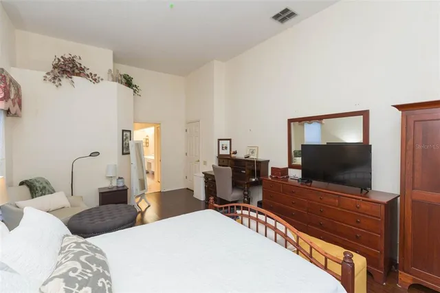 a bedroom with a bed and a flat screen tv