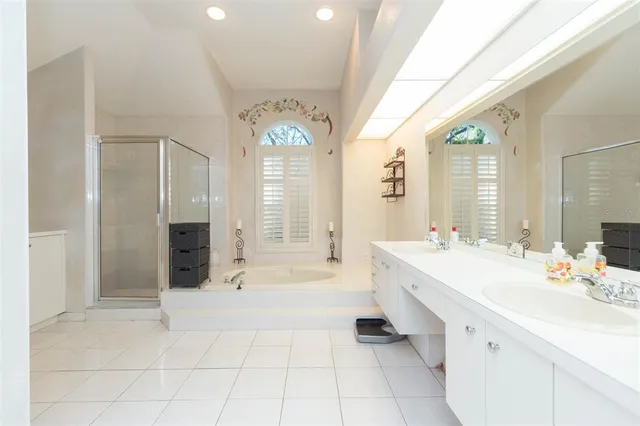 a spacious bathroom with a bathtub shower sink and mirror