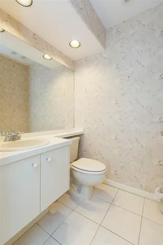 a bedroom with a bed and a computer on the desk