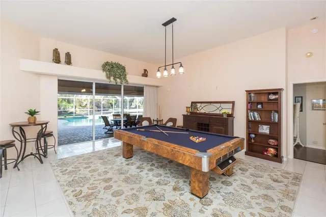 a living room with furniture a rug and a chandelier