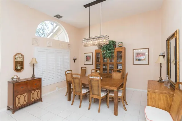 a view of a dining room with furniture and a chandelier