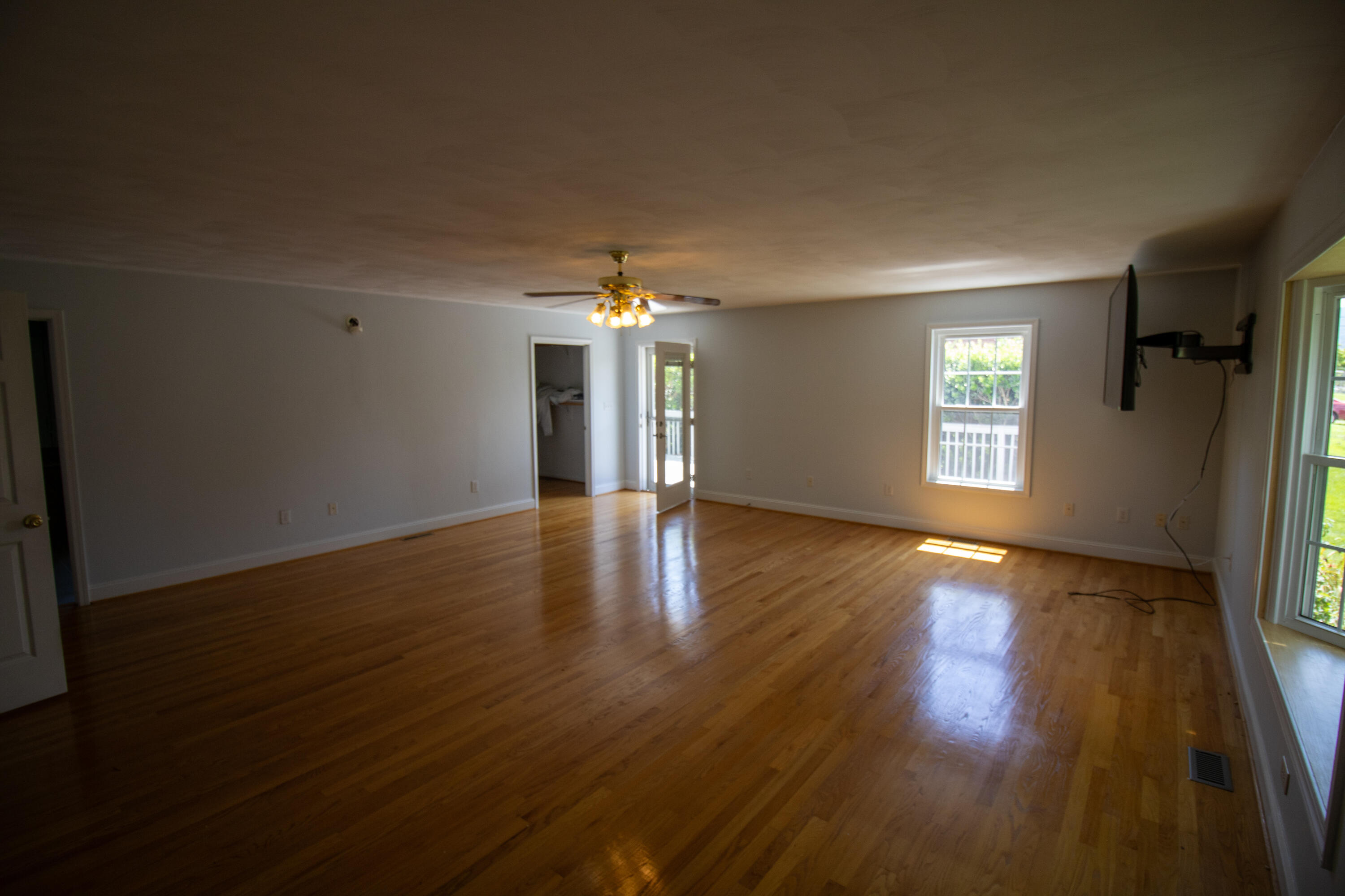 216 Goodwin Avenue Salem, VA 24153 - Photo 14 of 25 an empty room with wooden floor and windows