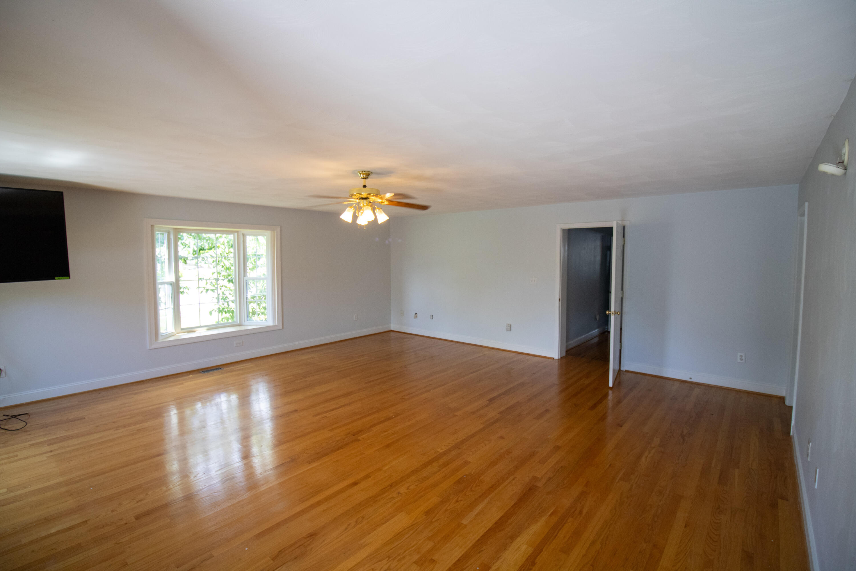 216 Goodwin Avenue Salem, VA 24153 - Photo 15 of 25 a view of an empty room with wooden floor and a window