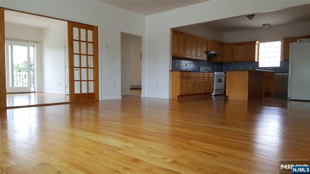 351 Main Avenue Wallington, NJ 07057 - Photo 4 of 9 a kitchen with stainless steel appliances granite countertop a stove and a wooden floors