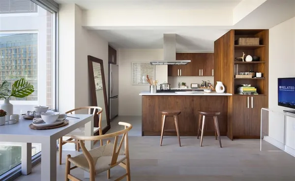 a dining room with furniture a window and kitchen view