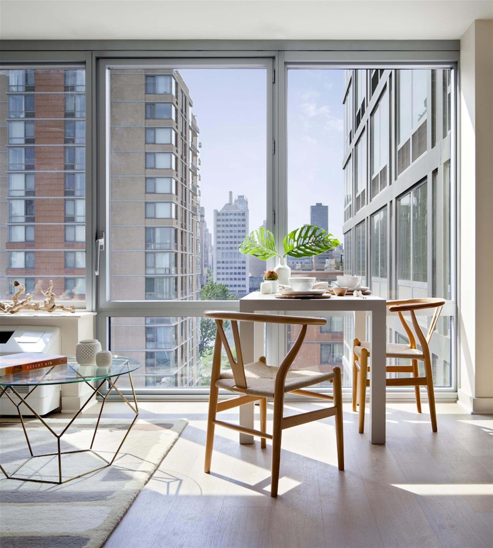 480 Main Street, Unit 20J Manhattan, NY 10044 - Photo 16 of 17 a room with table and chairs