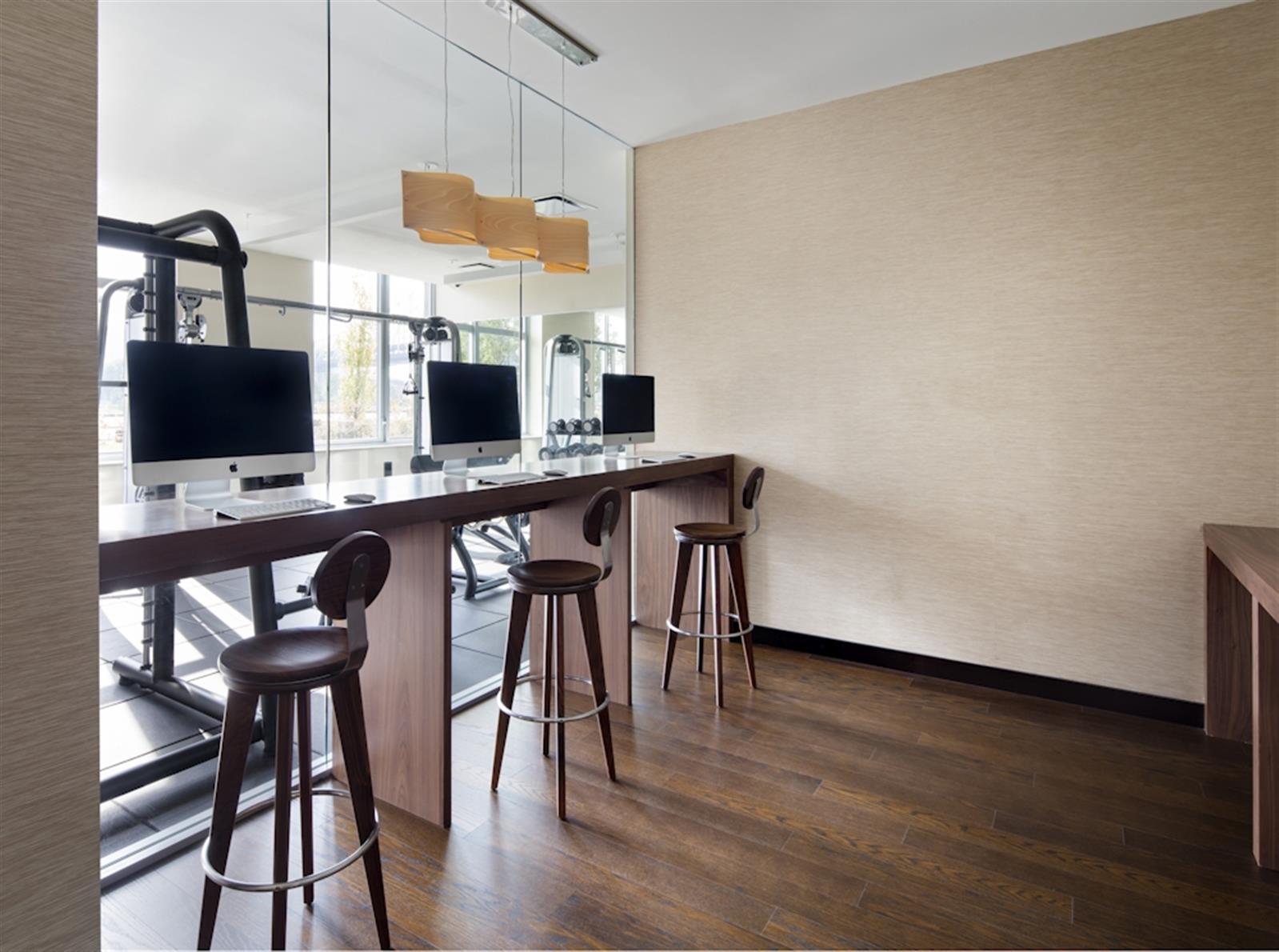 480 Main Street, Unit 20J Manhattan, NY 10044 - Photo 3 of 17 a view of a workspace with furniture and wooden floor