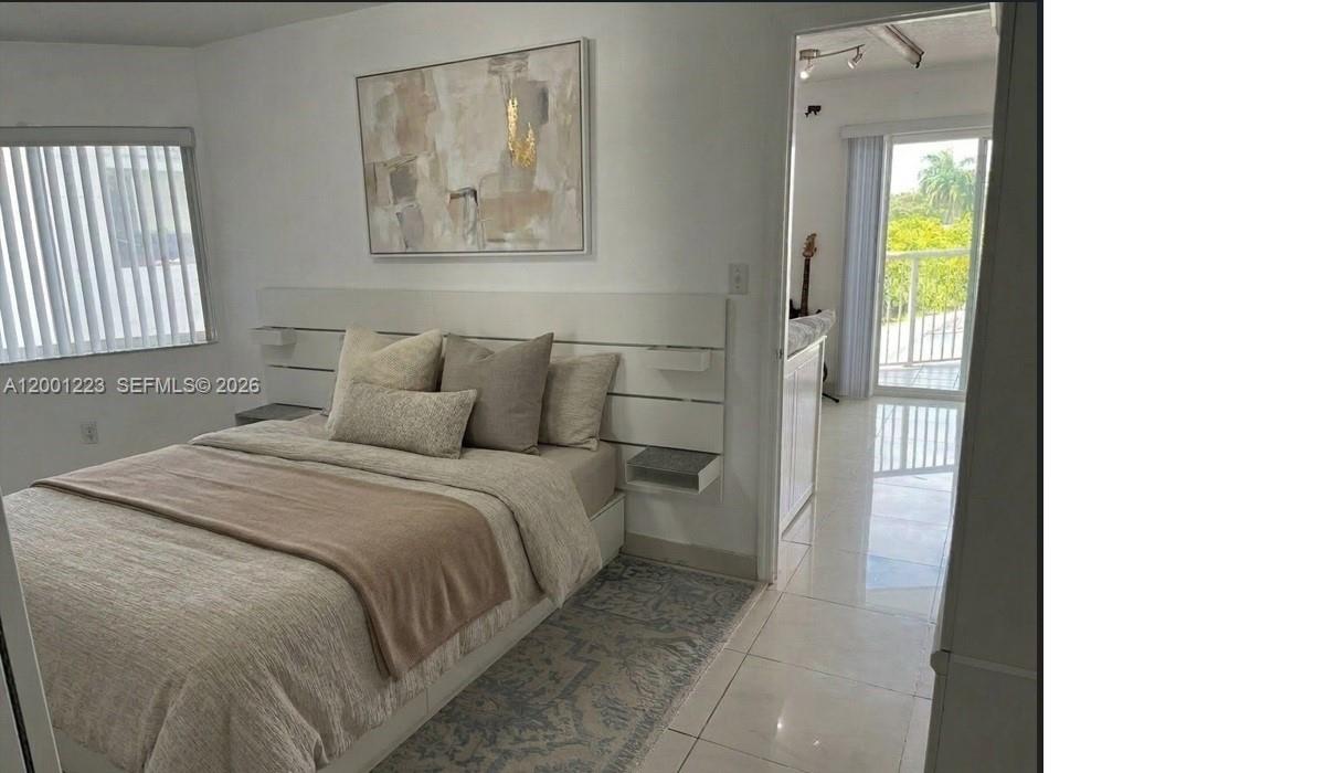 280 Southwest 20th Road, Unit 504 Miami, FL 33129 - Photo 21 of 23 a bedroom with a bed and a painting