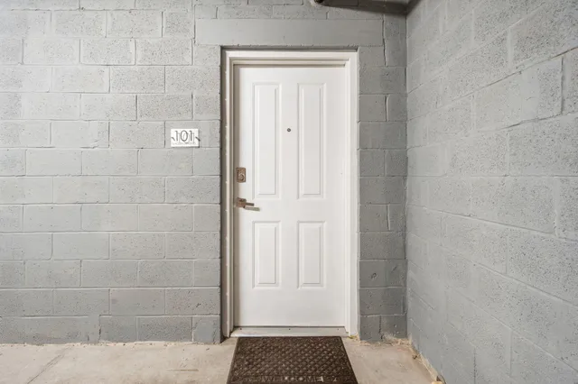 a kitchen with a sink window and cabinets