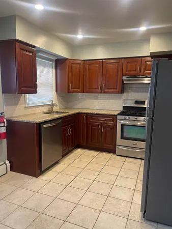 a kitchen with stainless steel appliances granite countertop a sink and cabinets