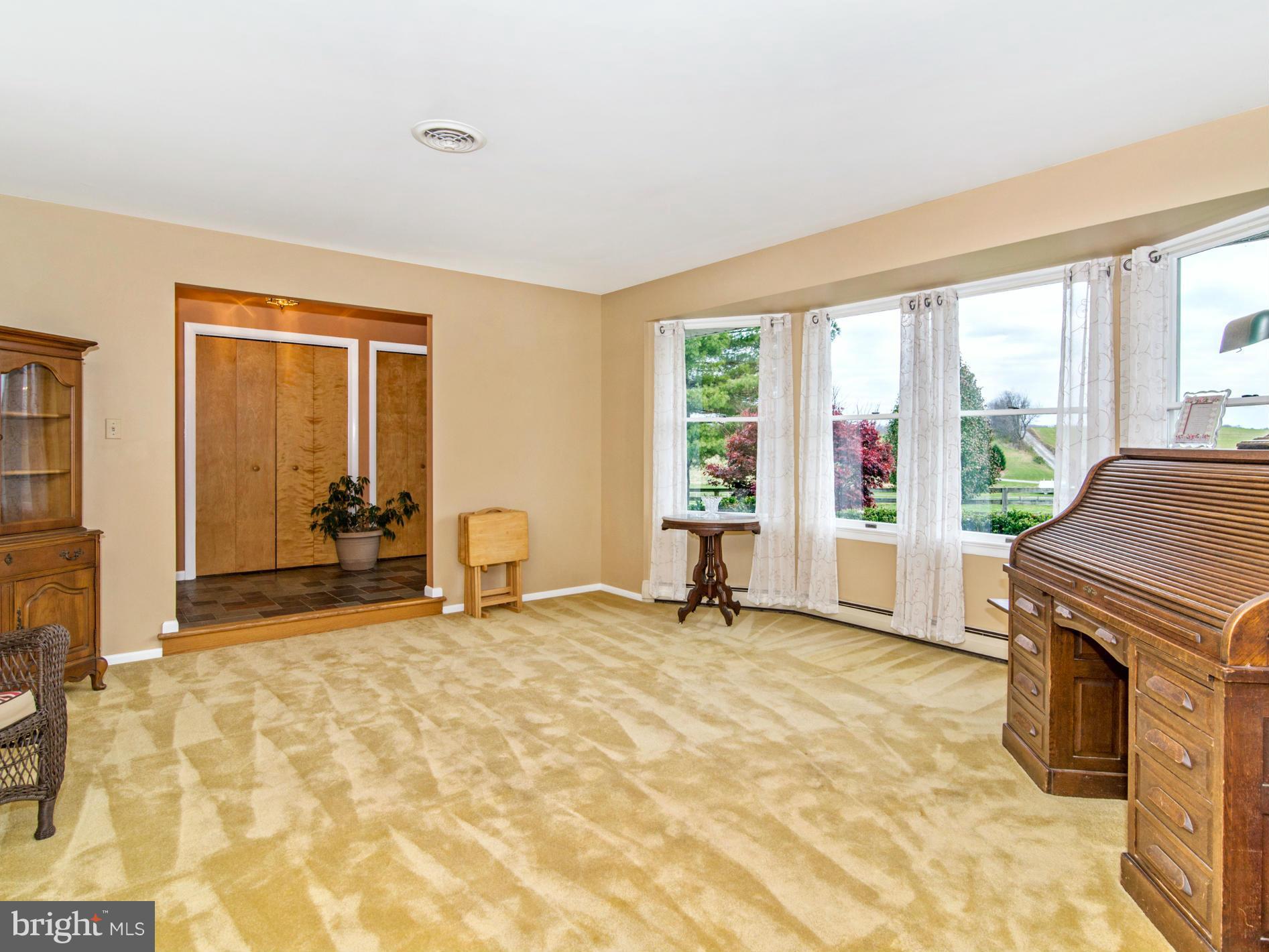 14040 Liberty Road Union Bridge, MD 21791 - Photo 3 of 30 a view of a livingroom with a fireplace and a window