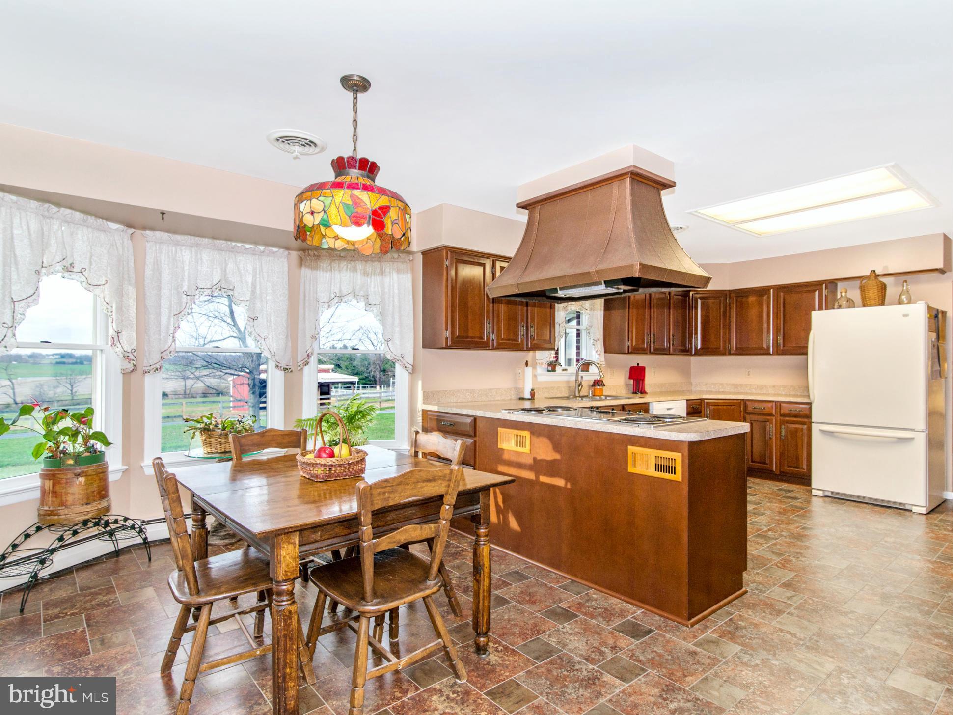 14040 Liberty Road Union Bridge, MD 21791 - Photo 6 of 30 a kitchen with a dining table and chairs
