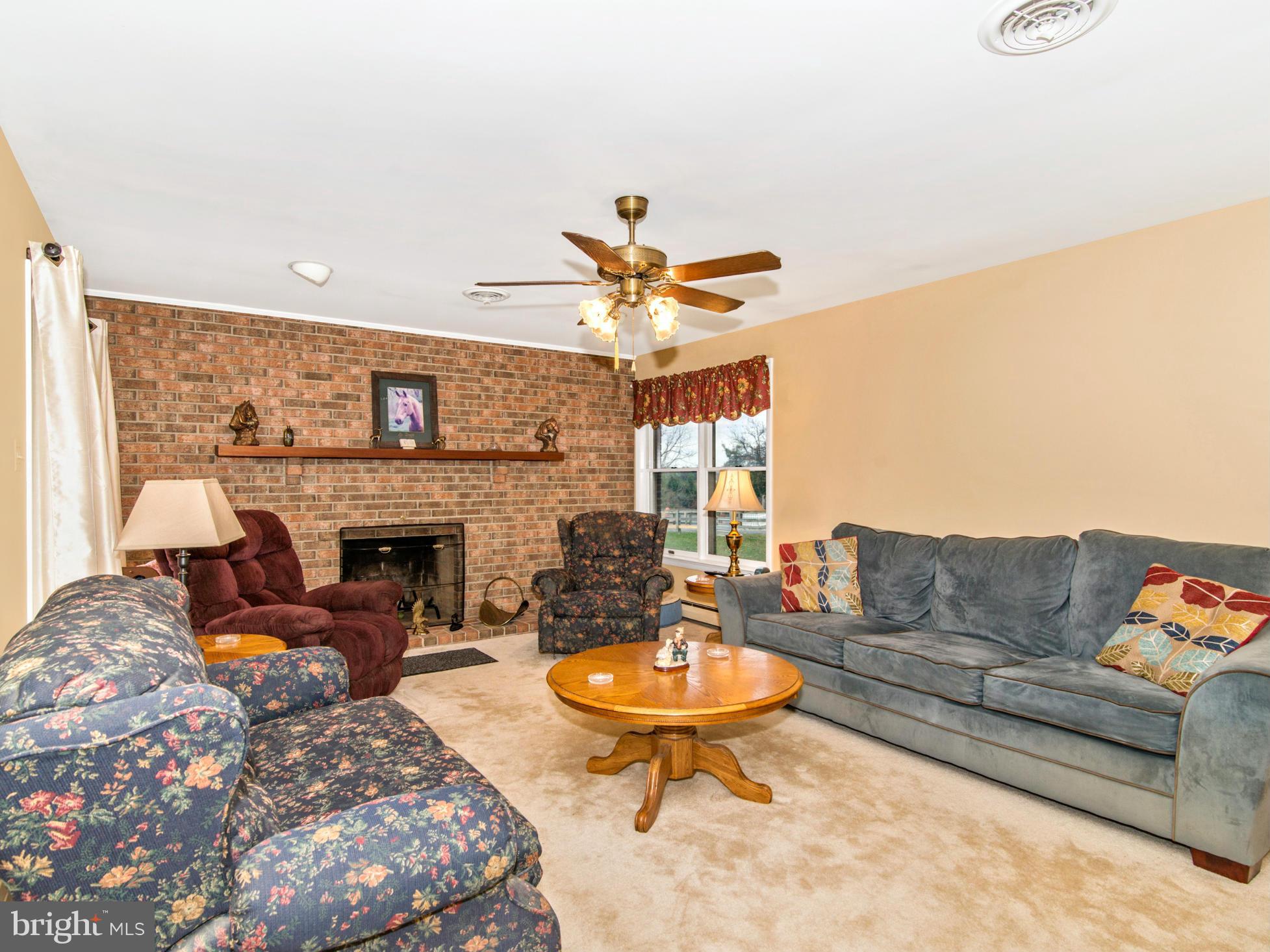 14040 Liberty Road Union Bridge, MD 21791 - Photo 10 of 30 a living room with furniture a fireplace and a chandelier