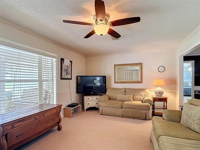 a view of a dining room with furniture a chandelier and window