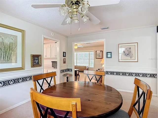 a kitchen with white cabinets and refrigerator