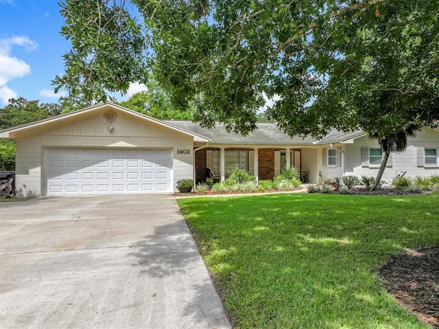 a front view of house with yard and green space