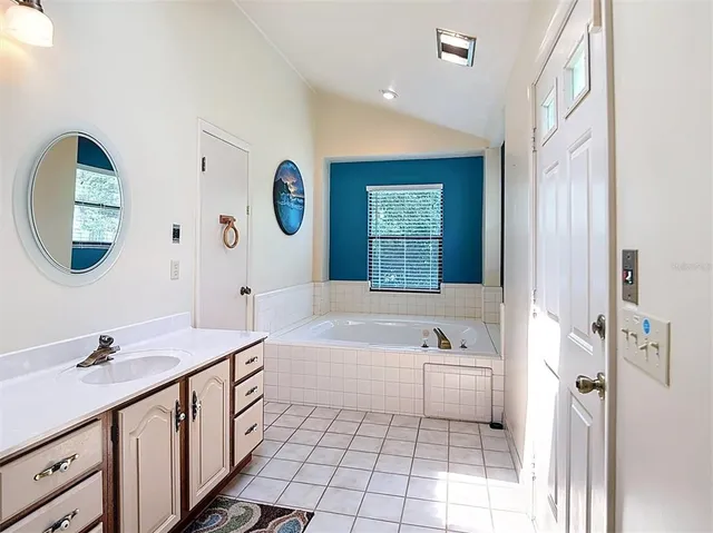 a bed room with a bed and a mirror