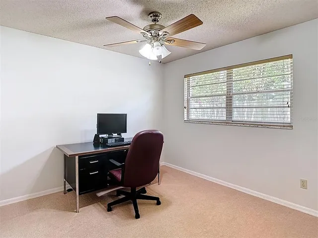 a bedroom with furniture and a large window