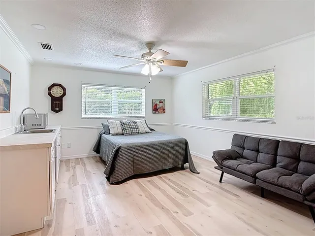 a view of a house with backyard and sitting area