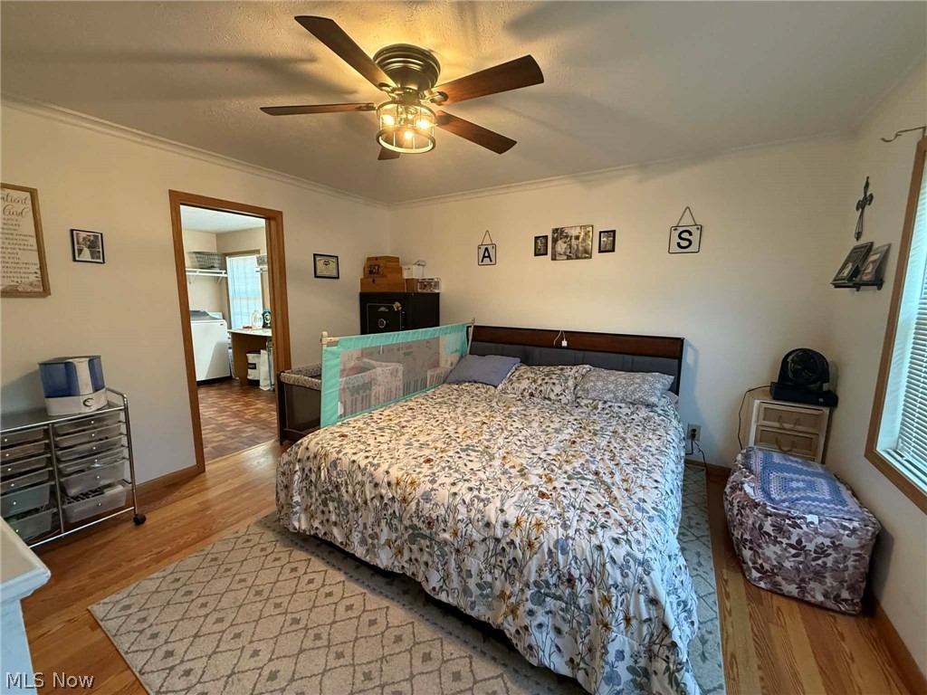 7170 Old Town Road Mount Perry, OH 43760 - Photo 12 of 41 Bedroom with light wood-style flooring, crown molding, and a ceiling fan