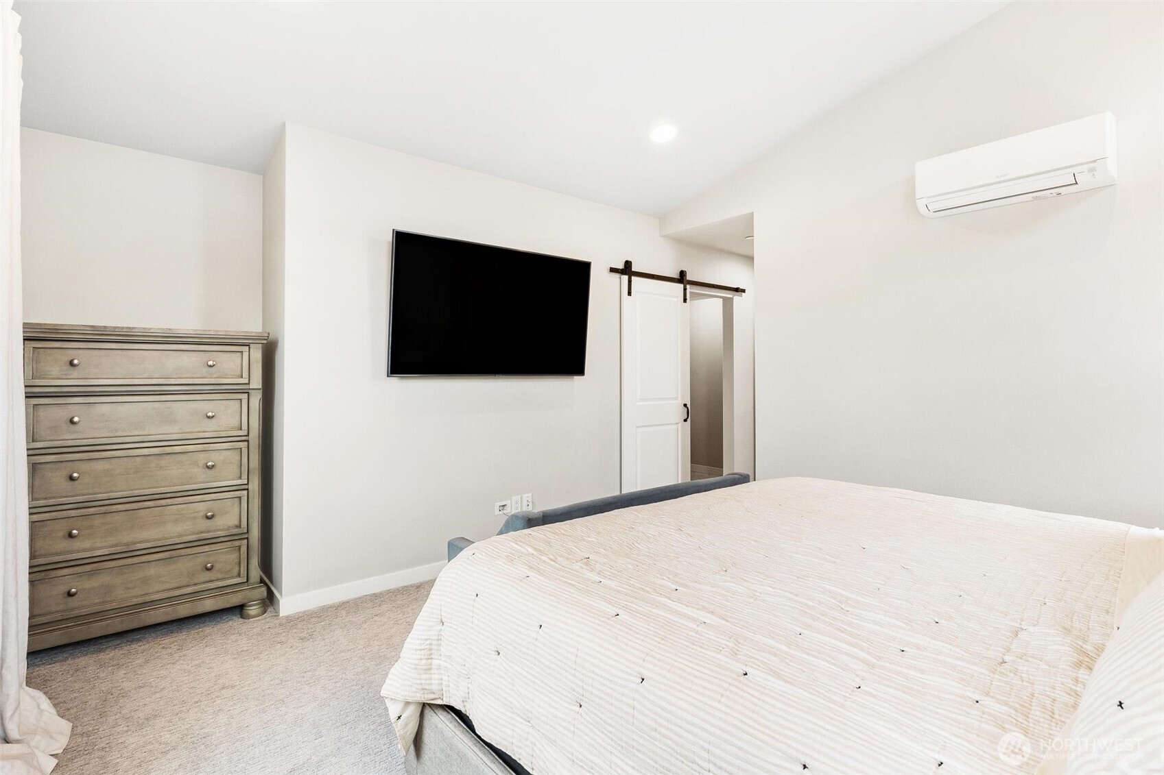 513 238th Street Southeast, Unit A Bothell, WA 98021 - Photo 24 of 31 a bedroom with a bed and a flat screen tv