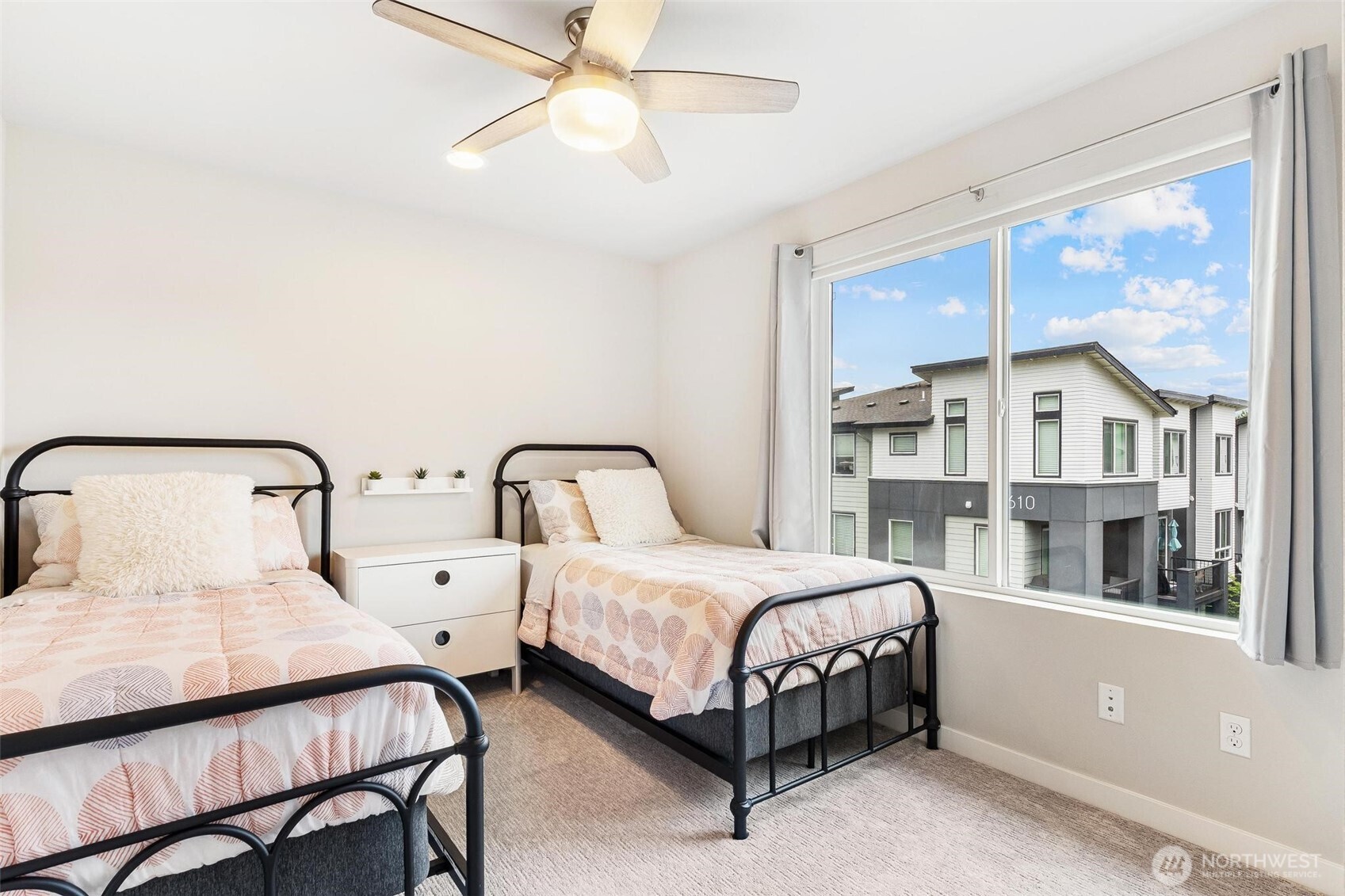 513 238th Street Southeast, Unit A Bothell, WA 98021 - Photo 26 of 31 a bedroom with a large bed and a chandelier