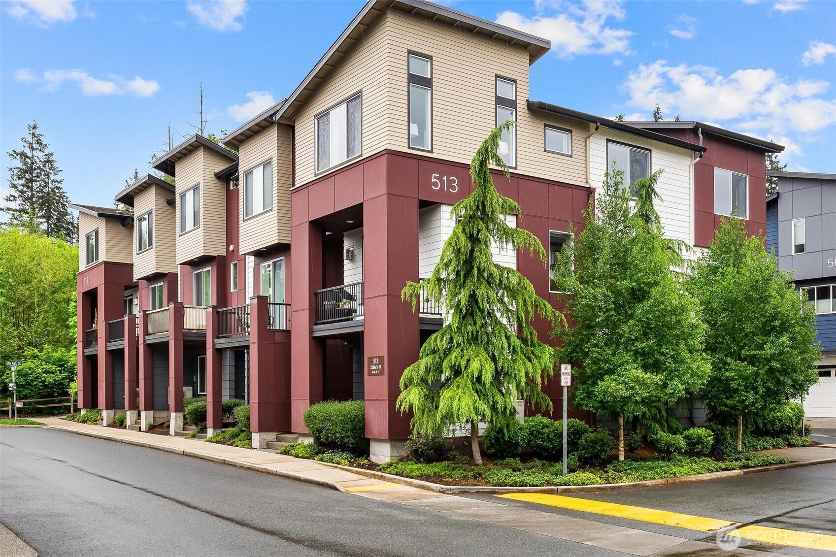 513 238th Street Southeast, Unit A Bothell, WA 98021 - Photo 4 of 31 a view of a white building among the street and palm trees