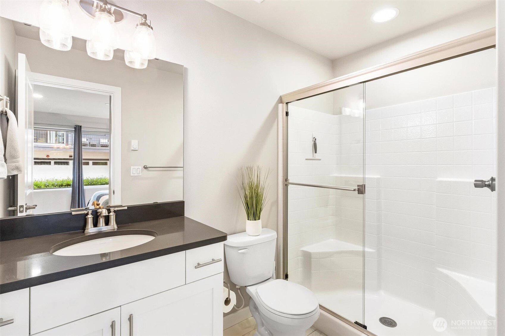 513 238th Street Southeast, Unit A Bothell, WA 98021 - Photo 10 of 31 a bathroom with a double vanity sink toilet and shower