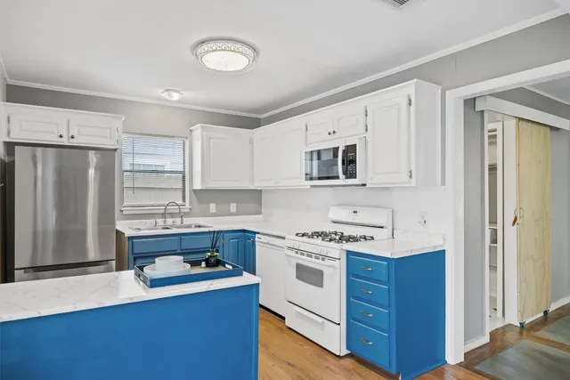 a kitchen with stainless steel appliances white cabinets and a stove